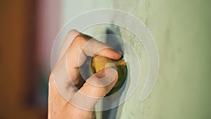 Climber`s hand slips from a rock, close up.