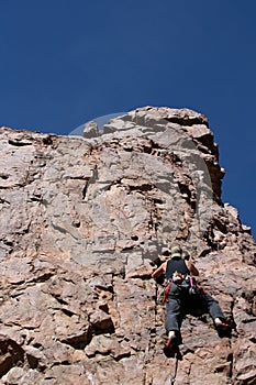 Climber scaling to peak