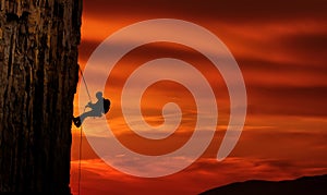 Climber silhouette over beautiful sunset