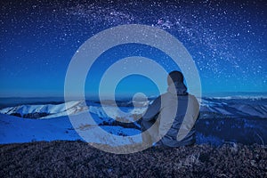 A climber sitting on a ground at night