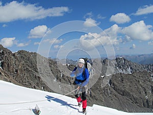 Climber on snow alpinist route