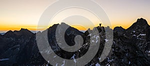 Climber standing on a mountain summit during sunrise, silhouette landscape from Europe, Slovakia