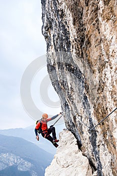 Climber on the steep rocky wall