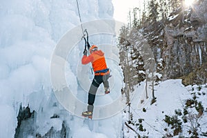 Climber swinging the ice axes