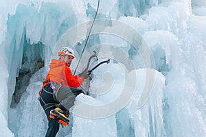 Climber swinging the ice axes