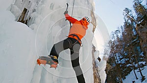 Climber swinging the ice axes