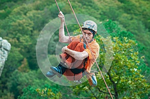 A climber swinging on a rope