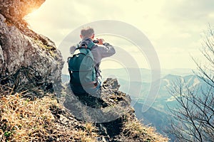 Climber take a mountain landscape photo on his smartphone