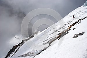 Climber traversing mountain slope at high altitude, Himalayas, Nepal