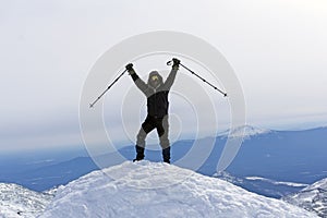 Climber triumphs on the top of the mountain