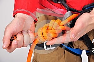 Climber tying double bowline knot