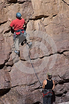 Climber up wall with belayer