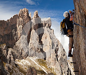 Climber on via ferrata in Italy dolomities