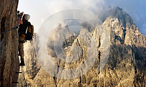 Climber on via ferrata or klettersteig in Italy