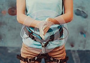 Climber woman coating her hands in powder