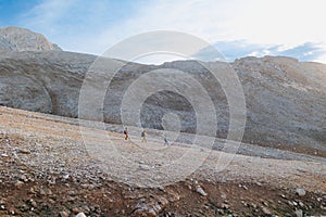 climbers with backpacks in the mountains. Tourists travel through the rocky mountains. Active recreation in mountain hikes.