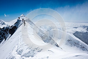 Climbers balancing in blizzard