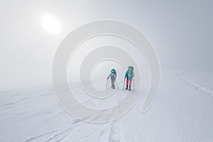 climbers climb the mountain. Winter mountaineering. two girls in snowshoes walk through the snow