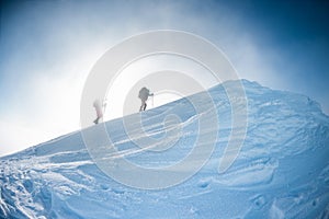 Climbers climb to the top of the mountain in winter