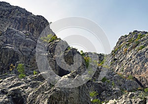 Climbers are climbing a rocky mountain in Paklenica, Croatia