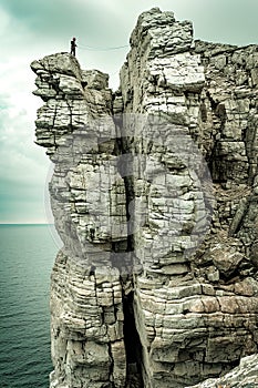 Climbers conquering challenging rock formations in mountain.