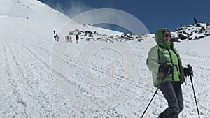 Climbers descend from the top of Elbrus. Panorama of the mountain, a nice sunny day.