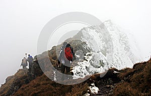 Climbers descending from Fagaras mountains on bad weather