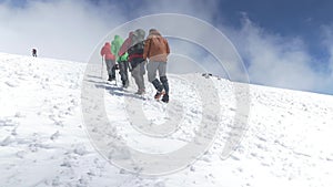 Climbers go up to the top on a snowy slope. On a nice sunny day. Mount Elbrus, Caucasus slow motion