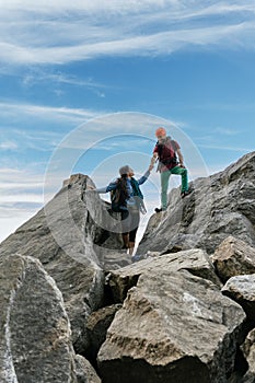 Climbers high-five each other at the top of the mountain