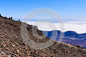 Climbers inspect a young volcano during clear weather