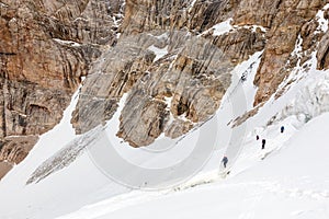 Climbers Linked with Protection Rope Ascending Glacier