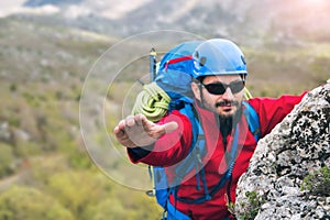 Climbers reaches the top of mountain peak, search help hand.