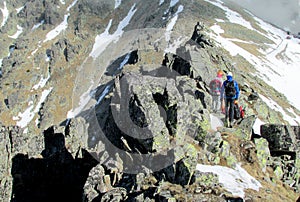 Climbers on the rock and snow alpinist route