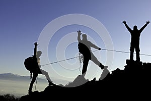 Climbers with rope on mountain range