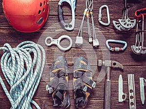 Climbing equipment  on dark wooden background, top view