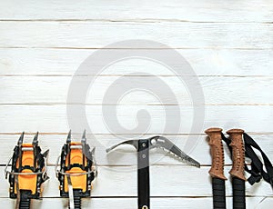 Climbing gear on white wooden background, top view