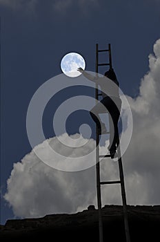 Climbing man to the moon in the sky