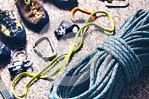 Climbing and mountaineering equipment on a carpet. Shoes, carbine, rope, lope, ascend-er. Concept of outdoor and extreme sport.