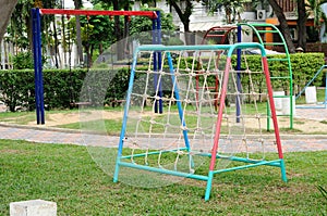 Climbing net and chain swing at playground.