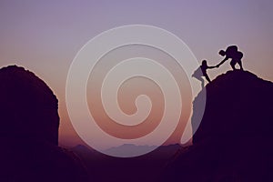 Climbing people in mountains as symbol for team spirit