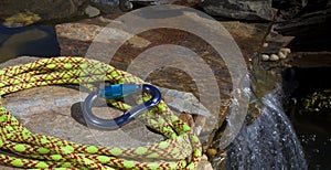 Climbing rope and carabiner next to water