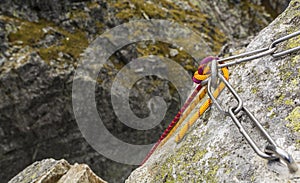 Climbing rope postponed by a rappel stance, prepared for descent from the summit.