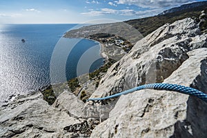 Climbing rope on top mountain with the view over village of Katsiveli. Crimea