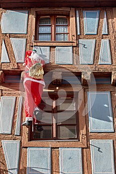 Climbing Santa on a half timbered house in the french city of Colmar, Alsace.