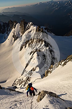 Climbing on snowy ridge in the French Alps
