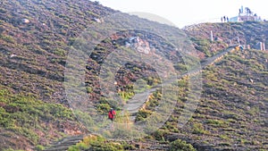 Climbing stairs to the top of the hill to see the beauty of Lake Kelimutu photo