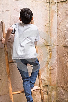 Climbing up on the high wall in an open shower area