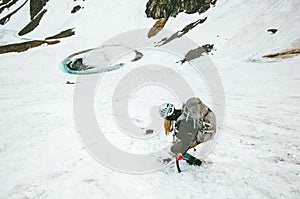 Climbing woman with backpack and ice axe mountaineering