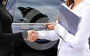 Clinching the purchase of a car and shaking hands