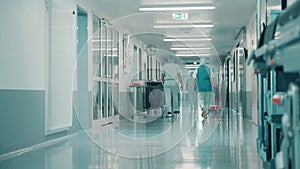 Clinic hallway with medical personnel walking through it